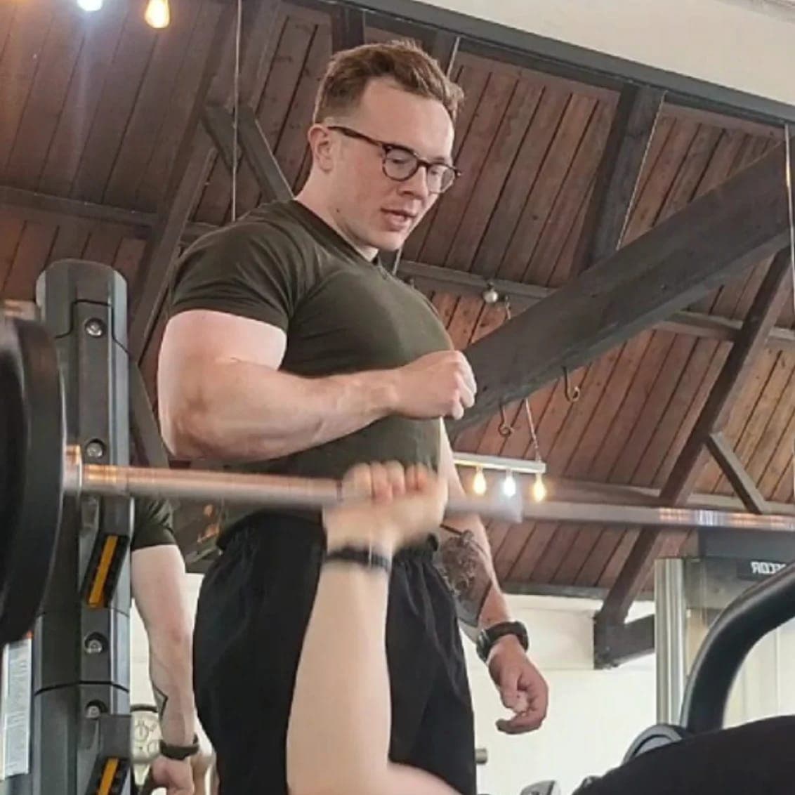 Harry Phillips coaching a client through a squat